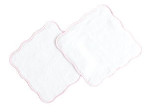 Terry Tots Wash Cloth Set: Two square, white plush wash cloths with scalloped edges and delicate light pink stitching, slightly overlapping on a white background—ideal for gentle cleansing.