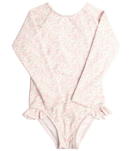 A long-sleeved, light pink floral-patterned Minnow Girls' Rashguard One Piece with buttery soft fabric and small ruffle hip details, offering UPF protection.