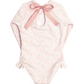 A pink floral-patterned baby onesie with long sleeves, an open back, a pink bow at the top, and ruffle hip detail. Made from buttery soft fabric for ultimate comfort is Minnow Girls' Rashguard One Piece by Minnow.