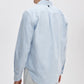 A person is seen from the back against a plain light background, wearing the Rag & Bone Classic Oxford Shirt in light blue and white stripes with a classic fit.