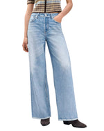 Person wearing Rag & Bone Miramar Terry Sofie Wide Pant, a striped short-sleeve top, and black heeled boots, with hands in the pant pockets.