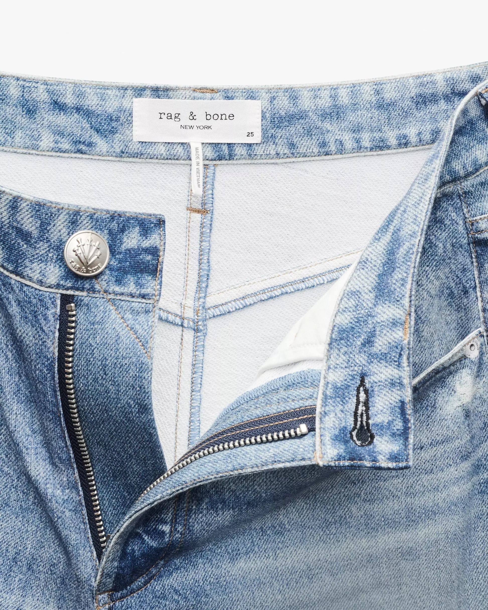 Close-up of light blue Miramar Terry Sofie Wide Pant by Rag & Bone, high-rise style with zipper open, revealing white pocket lining and Rag & Bone label on waistband.