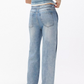 A person wearing Rag & Bone’s Miramar Terry Wide Track Pant in light blue with a sleeveless denim top, shown from the back against a plain white background.
