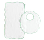 The Bib & Burp Set from Terry Tots features a white rectangular burp cloth and a round scalloped-edge bib with green trim, both displayed on a white background—perfect companions for everyday feeding moments.