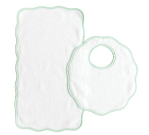 The Bib & Burp Set from Terry Tots features a white rectangular burp cloth and a round scalloped-edge bib with green trim, both displayed on a white background—perfect companions for everyday feeding moments.