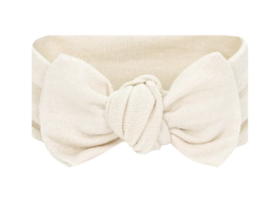 The Lou Lou & Company Baby Girls’ Dakota Plush Knit Headband is a beige fabric headband featuring a large knotted bow in the center.