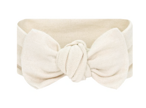 The Lou Lou & Company Baby Girls’ Dakota Plush Knit Headband is a beige fabric headband featuring a large knotted bow in the center.