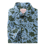 A neatly folded Pink House Mustique Printed Linen Shirt featuring long sleeves and a green floral pattern on a light blue background, capturing the laid-back elegance of Mustique.