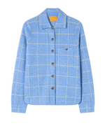 The Dylan Plaid Shirt by Guest in Residence is a light blue, western-style button-up with a white grid pattern, brown buttons, and a single chest pocket. Made from a cashmere-linen blend, it's shown on a plain white background.