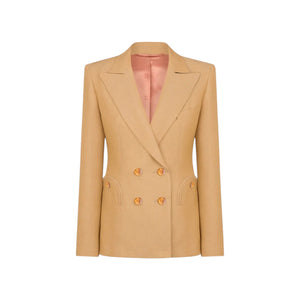 The Renegade Charmer Blazer by Blaze Milano is a beige women's double-breasted linen blazer with gold buttons and a notched lapel, designed for a polished hourglass silhouette, shown on a white background.