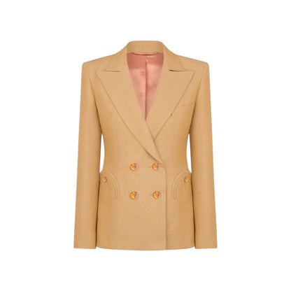 The Renegade Charmer Blazer by Blaze Milano is a beige women's double-breasted linen blazer with gold buttons and a notched lapel, designed for a polished hourglass silhouette, shown on a white background.