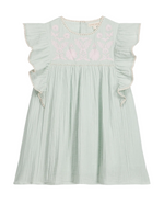 The Girls’ Taliana Dress by Louise Misha is a light green cotton gauze dress for girls, featuring ruffled short sleeves, an embroidered floral pattern on the chest, and a loose, pleated skirt.