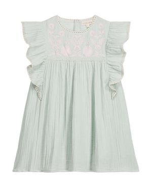 The Girls’ Taliana Dress by Louise Misha is a light green cotton gauze dress for girls, featuring ruffled short sleeves, an embroidered floral pattern on the chest, and a loose, pleated skirt.