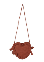 The Noralee Girls' Heart Purse is a heart-shaped brown handbag made from heart eyelet fabric with ruffled edges and embroidered details. This charming accessory features a long thin strap and is shown against a white background.