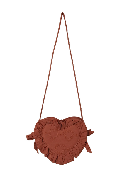 The Noralee Girls' Heart Purse is a heart-shaped brown handbag made from heart eyelet fabric with ruffled edges and embroidered details. This charming accessory features a long thin strap and is shown against a white background.
