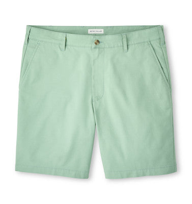 The Peter Millar Crown Comfort Short for men in light green features a traditional texture, side pockets, plain weave fabric, and a front button closure, shown on a white background.