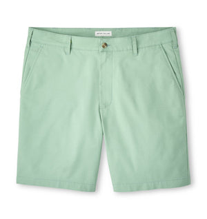 The Peter Millar Crown Comfort Short for men in light green features a traditional texture, side pockets, plain weave fabric, and a front button closure, shown on a white background.