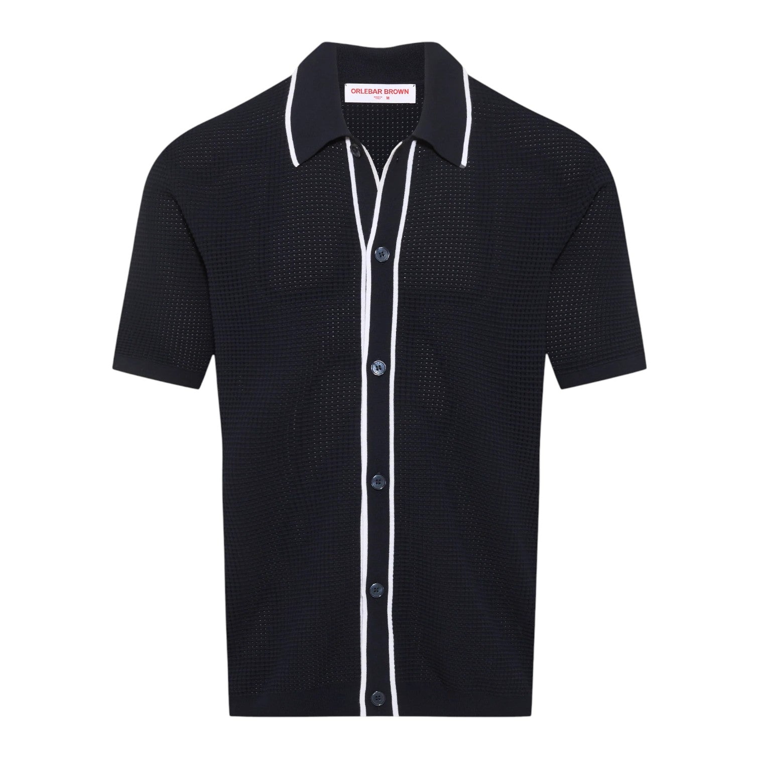 The Orlebar Brown Roddy Button Through Knitted Shirt is a short-sleeve black waffle mesh style with white piping at the collar, placket, and pocket seams, finished with textured summer tailoring and a "Chelsea Brown" label inside.