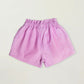 Early Sunday Girls’ Roman Shorts in light pink cotton-linen feature an elastic waistband for comfort and easy wear. Displayed flat on an off-white background, these breathable shorts combine everyday style with play-ready ease—ideal for active kids.