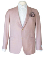 The Samuelsohn Baylor Blazer, a light pink suit jacket, draped over a white dress shirt and adorned with a paisley pocket square in the left chest pocket, exudes the heritage of men's luxury clothing through its superior craftsmanship.