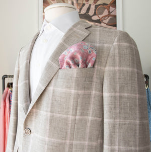 Mannequin dressed in a Samuelsohn Bristol Contemporary Fit Blazer with superior craftsmanship, paired with a white shirt and a pink paisley pocket square, displayed in a men's luxury clothing store.