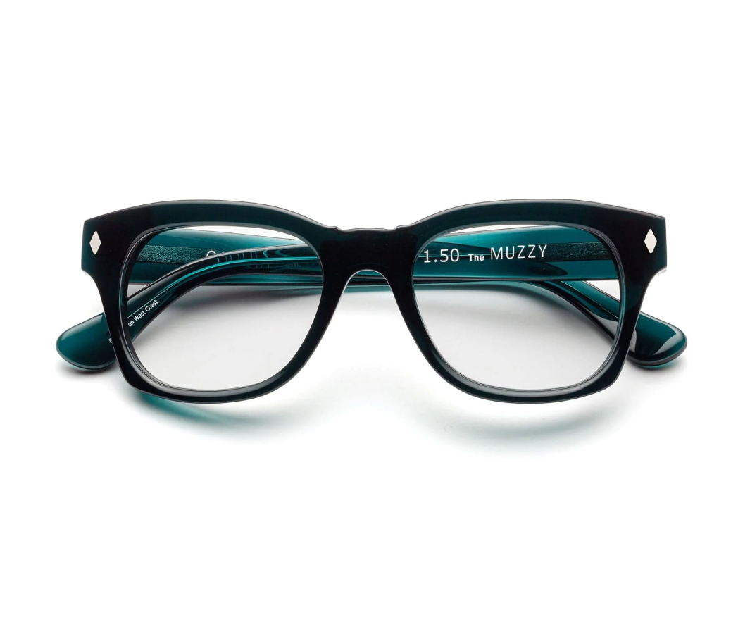 The Caddis Muzzy Reader features black rectangular eyeglasses with thick bio-based acetate frames and clear, premium hard-coated lenses, shown from the front on a white background.