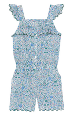 The Girls’ Liberty Print Short Jumpsuit by Tartine et Chocolat is a floral-patterned, sleeveless cotton romper for children, featuring ruffled straps, a button front, scalloped edges, and an elastic waist in predominantly blue, green, and pink hues—perfect for summer.
