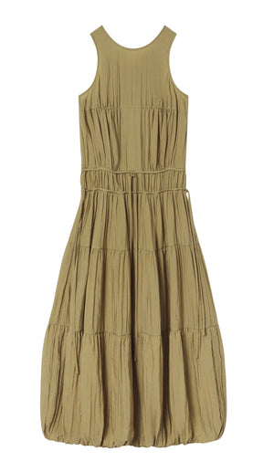 The CO Soft Pleated Turn Up Midi Dress is a sleeveless, light brown dress with a round neckline, thin drawstring waist, and pleated texture.