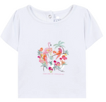 The Baby Girls’ and Girls’ Tropical T-shirt by Tartine et Chocolat is a white short-sleeve cotton tee adorned with a tropical print, embroidered flamingo, vibrant flowers, palm trees, and “Tartine et Chocolat” text on the front—ideal for a breezy summer look.