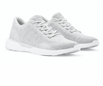 The Peter Millar Glide V3 Sneaker is a light gray slip-on athletic shoe with white soles and laces, featuring a performance mesh sockliner for flexible comfort, shown on a white background.