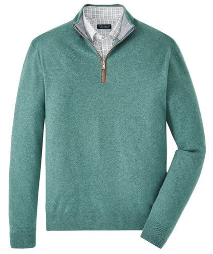 The Peter Millar Artisan Crafted Cashmere Flex Quarter-Zip in green, inspired by classic British Isles knitwear, is layered over a light gray plaid collared shirt and displayed flat on a white background.