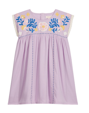 The Girls’ Talula Dress by Louise Misha is a lavender sleeveless dress made from soft cotton veil, adorned with floral embroidery on the chest, delicate lace trim on the shoulders, and blue stitched lines running vertically down the front.
