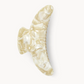 The Machete Jumbo Heirloom Claw is a cream-colored, marbled hair clip made from glossy Italian acetate with curved edges—ideal for holding long or thick hair—shown on a plain white background.