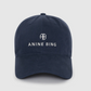 The Jeremy Baseball Cap by Anine Bing is a navy blue cotton-twill hat with "ANINE BING" and a circular AB logo embroidered in white on the front, plus an adjustable back strap for a custom fit.