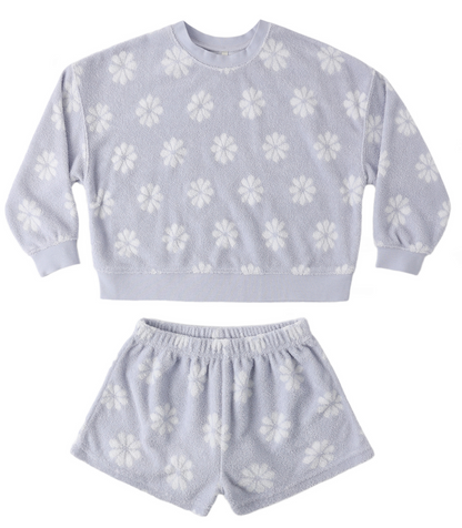 The Baby Girls' and Girls' Karli Set by Rylee & Cru is a light purple terry cloth loungewear set with a long-sleeve top and shorts, featuring a white floral pattern—ideal for relaxed summer days.