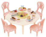 The Calico Critters Sweets Party Set features a vibrant round table with four pink chairs, beautifully arranged with toy food, drinks, animal-shaped treats, and a tiered dessert tray for imaginative tea party play. Complete with adorable teatime accessories, this set inspires endless creative fun and storytelling.