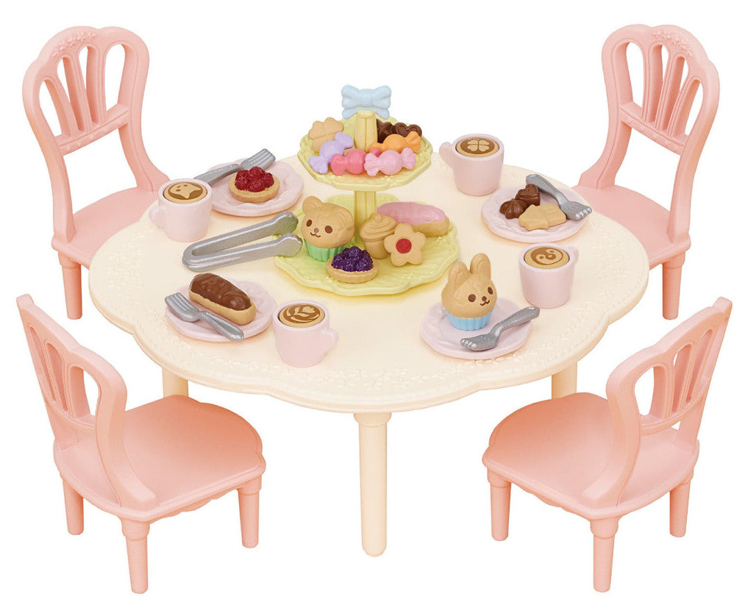 The Calico Critters Sweets Party Set features a vibrant round table with four pink chairs, beautifully arranged with toy food, drinks, animal-shaped treats, and a tiered dessert tray for imaginative tea party play. Complete with adorable teatime accessories, this set inspires endless creative fun and storytelling.