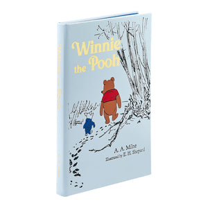A hardcover edition of "Winnie the Pooh" by Graphic Image, featuring E. H. Shepard’s classic illustrations of Pooh and Piglet walking together under trees.