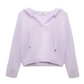 The Modern Statements Pullover by Dorothee Schumacher is a light purple Merino-cashmere hooded top with long sleeves, a V-neck, and drawstrings, shown on a plain background.