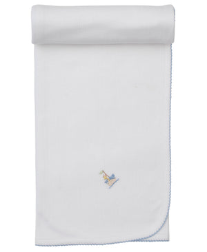The Kissy Kissy Premier Noah's Ark Blanket with Hand Emb. is a white Pima cotton baby blanket with light blue trim and a small embroidered giraffe and train near one corner, rolled at the top.
