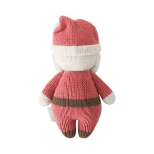 The Baby Santa knitted plush toy by Cuddle + Kind is shown from the back, dressed in a red and white outfit with a hat, against a plain white background.