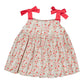 The Kidiwi Baby Girls' Sariette Smocked Blouse features 100% cotton, pink floral and cherry red print, and two wide shoulder straps tied in large red bows.