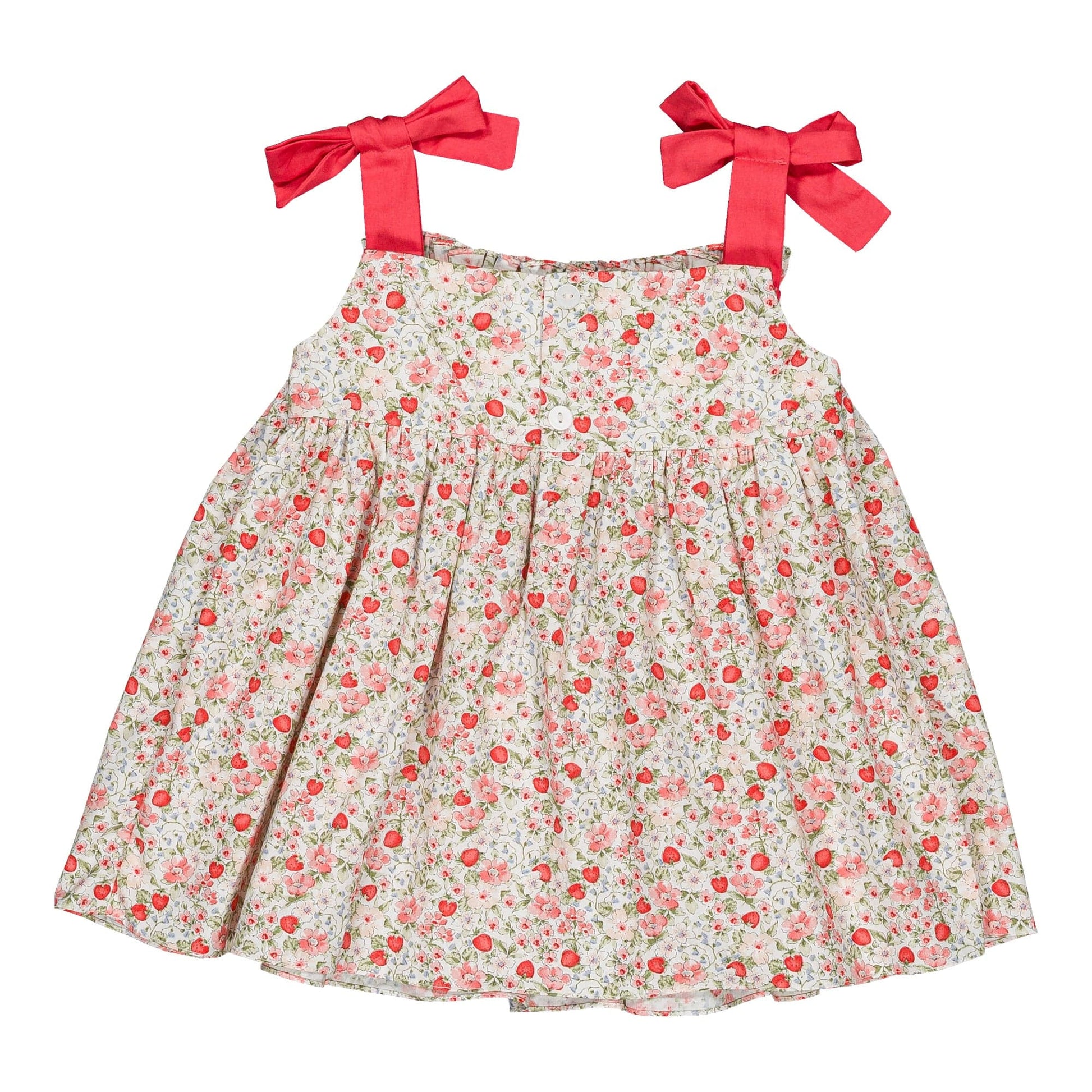 The Kidiwi Baby Girls' Sariette Smocked Blouse features 100% cotton, pink floral and cherry red print, and two wide shoulder straps tied in large red bows.