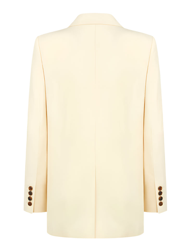 Back view of the Savannah Everyday Blazer by Blaze Milano in cream, made from a silk and linen blend, with cuff button details and a center seam.