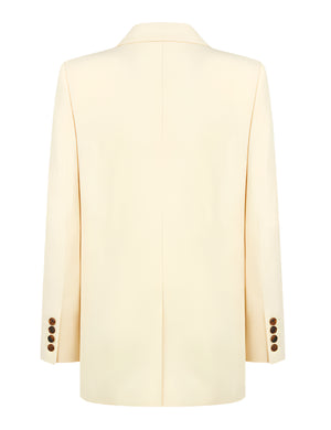 Back view of the Savannah Everyday Blazer by Blaze Milano in cream, made from a silk and linen blend, with cuff button details and a center seam.