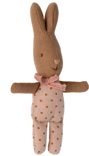 Introducing the Maileg "Rabbit with Dots - My": a brown fabric baby rabbit doll, dressed in a pink polka-dot outfit and adorned with a pink crocheted bow around its neck. Seen from the front, it's perfect for any dollhouse or as a charming companion for imaginative babysitter adventures.