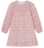 The Girls’ Flowery Print Cotton Dress by Tartine et Chocolat is a long-sleeved dress for girls, made from unbleached cotton with a white base, decorated with a pink floral print and gathered detailing at the chest, shown laid flat against a white background.