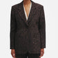 A person wears the Blaze Milano Simba Daisy Blazer in dark brown leopard print with structured shoulders and matching pants, standing against a plain white background.