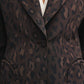 Close-up of a person wearing the Simba Daisy Blazer by Blaze Milano, featuring a chic women's leopard print design over a white top with a single front button fastened.