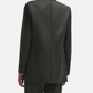 A person is seen from behind wearing a Nahalin Everyday Blazer in dark green with matching trousers by Blaze Milano, set against a plain white background.
